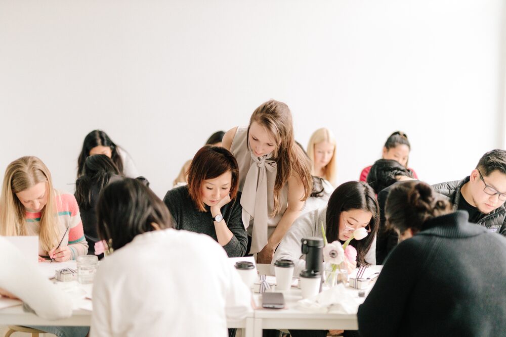 Guests seated around a long table at a hands-on workshop