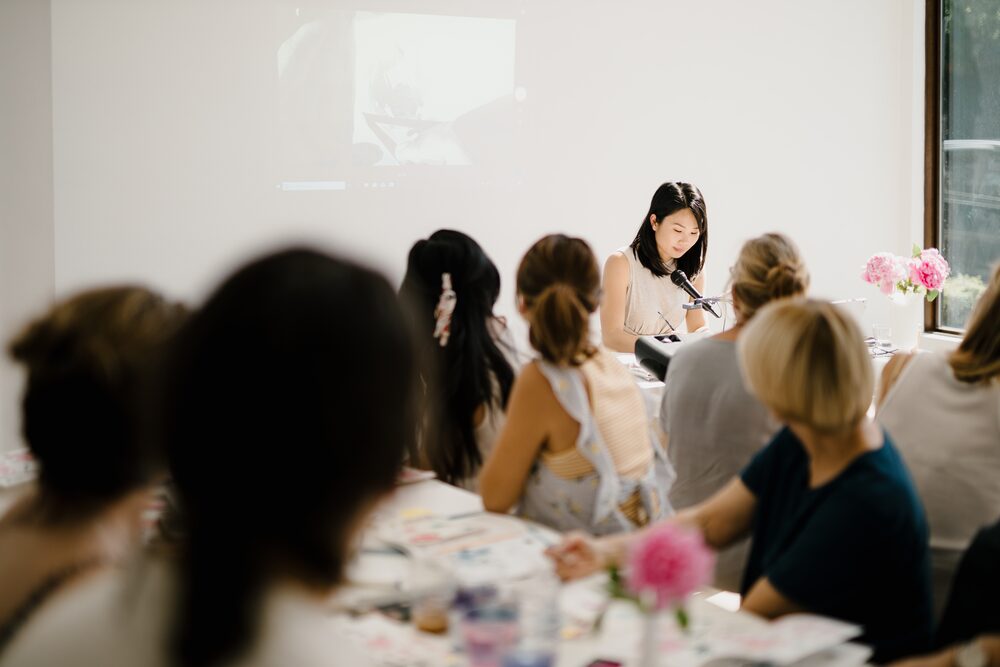 Audience watching a presenter in a bright room