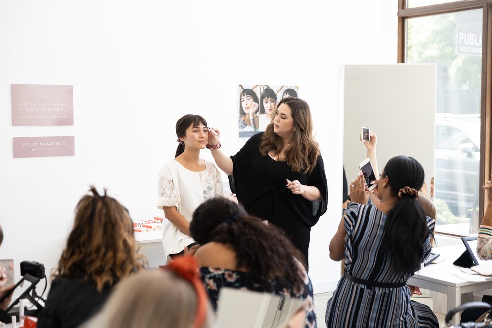 Guests talking in front of artwork at a gallery gathering