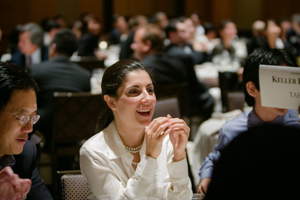 Guests laughing at a banquet table