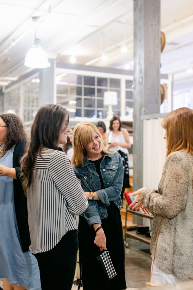 Guests chatting at a busy indoor market