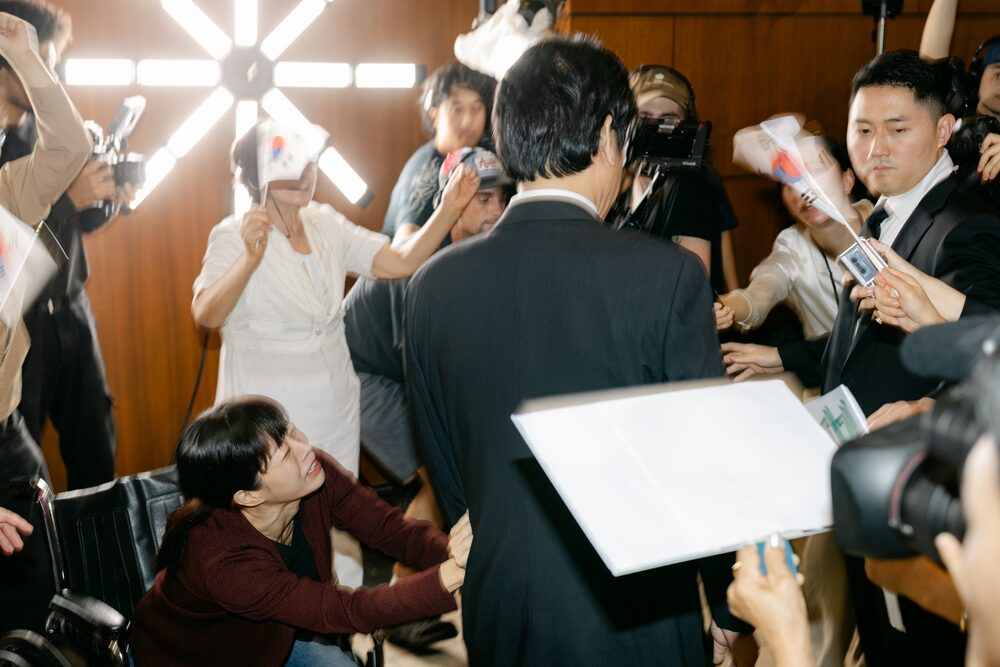 Crowd scene with flags and papers on a staircase