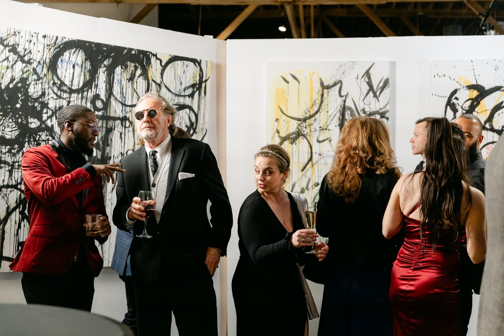 Guests in formal wear at a gallery reception