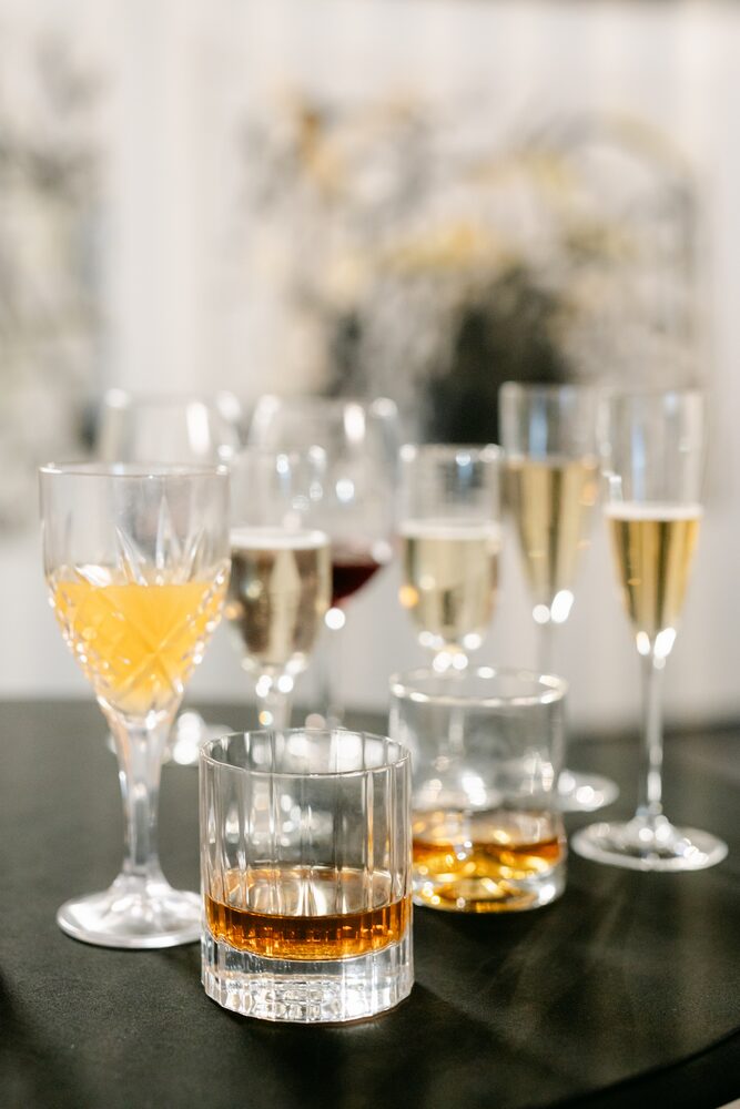 Champagne flutes and whisky glasses on a bar